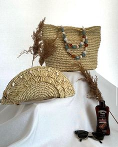 This handcrafted shoulder bag, featuring a button closure and beaded straps, is the perfect choice for the beach. The interior is lined, ensuring your belongings are carried safely. Meticulously woven with wicker using traditional craftsmanship, this model combines aesthetics and functionality to enhance both your style and comfort. Ideal for the beach or daily use, this bag will add an elegant touch to your look. We offer customization options for the wicker threads of our products in any color Summer Rectangular Crochet Bag, Bohemian Handheld Shoulder Bag For Beach Season, Summer Beaded Bags For Daily Use, Summer Beaded Pouch Bag, Beach Season Shoulder Bag Pouch, Bohemian Beaded Beach Bag For Summer, Natural Color Pouch Shoulder Bag For Beach, Beaded Crochet Rectangular Bag For Beach, Natural Pouch Shoulder Bag For Beach