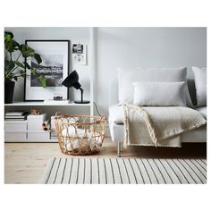 a white bed sitting next to a wooden floor