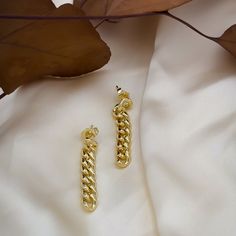 If you’re looking for a bold, statement-making earring that won’t break the bank, then this is it. With its 18k gold-filled Cuban link chain and drop style stud design, our Tatum Chain Link Earring is the perfect way to add some sass and glamor to your outfit. Wear them with jeans and t-shirt or dress them up with a cocktail dress and heels-no matter how you wear them, they’ll be sure to turn heads! Yellow Gold Chain Earrings For Everyday, Everyday Yellow Gold Chain Earrings, Gold-plated Dangle Earrings With Cable Chain, Gold Plated Dangle Earrings With Cable Chain, Yellow Gold Dangle Earrings With Chain, Elegant Chain Link Earrings With Gold Chain, Yellow Gold Chain Link Earrings For Gift, Yellow Gold Chain Link Earrings, Gold Plated Yellow Gold Chain Earrings