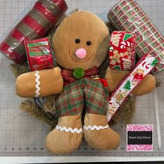 a teddy bear with christmas wrapping around it