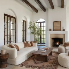 a living room filled with furniture and a fire place in the middle of a room