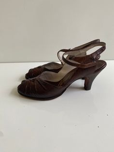 "Vintage 1950s Palizzio New York Leather Sandals Free Shipping These vintage heeled sandals are leather uppers. They are in good vintage condition and have new heel tops and new leather soles. They are tiny. The sole on the inside is just under 9.5\" long and the ball of the foot is 3\" across. The surface of the leather is embossed and could be reptile skin. The brand is Palizzio New York.  I believe them to be a size 6 or 6.5." Vintage Heels With Heel Strap, Vintage Heels With Penny Strap And Almond Toe, Vintage Brown Sandals With Low Heel, Vintage Brown Low Heel Sandals, Retro Closed Toe Sandals With Leather Sole, Vintage Almond Toe Heels With Penny Strap, Vintage Closed Toe Heels With Penny Strap, Vintage Leather Sandals With Round Toe, Vintage High Heel With Penny Strap