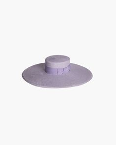 The Bey hat is a flat-brimmed shape made of Squishee® popularized by the singer-songwriter of that nickname. The dramatic brim is flattering, adds stature, and provides maximum sun protection. This structured shape features a flat-topped crown, banded with cotton grosgrain ribbon finishing to the side in a man-tailored bow. Squishee® is a man-made material incorporating recycled fibers that is lightweight and packable. It will not crack with wear or melt when wet and is more durable and lightwei Hat Wide Brim, Boater Hat, Wide Brimmed, Straw Hat, Grosgrain Ribbon, Recycled Plastic, Singer Songwriter, Hats For Women, Sun Protection