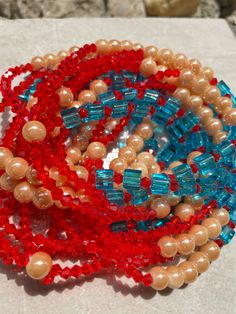 Double Strand Waist Bead "Divo" features two strands adorned with vibrant red crystal glass beads, large square blue crystal glass beads, and luxurious gold round glass seed beads. Immerse yourself in the regal charm and customizable elegance of this waist bead, crafted to add a touch of opulence to your ensemble. 🔴 Vibrant Red Crystal Glass Beads: The first strand showcases vibrant red crystal glass beads, radiating energy and passion. The red beads created a bold and dynamic foundation, symbo Waist Beads, Red Beads, Glass Seed Beads, Red Crystals, Red Bead, Blue Beads, Blue Crystals, How To Make Beads, Gold Beads