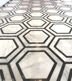 a marble floor with black and white hexagon tiles on it's sides