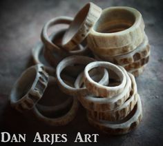 several wooden rings stacked on top of each other with the words dan aries art above them