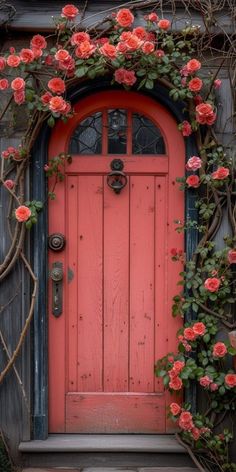 an orange door with pink flowers growing over it