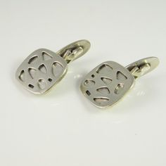 A timeless classic pair of original mid century modernist cuff links circa 1950 hand made in fine 900 European silver. These classy one of a kind cuff links are iconic of the era. They have a cool abstract design with an atomic design pattern across them which is eye catching and unusual. The pair have a quite deliberate texture to them which is most clear in the recessed silver shapes on the cufflink faces. Together the pair weigh 12.82 grams. They are each clearly marked for 900 fine silver an Vintage Polished Cufflinks As Gift, Vintage Rectangular Cufflinks For Gifts, Mid-century Handmade Formal Jewelry, Modernist Cuff Jewelry For Gift, Vintage Engraved Cufflinks For Anniversary, Vintage Silver Engraved Cufflinks, Vintage Silver Cufflinks For Wedding, Vintage Silver Wedding Cufflinks, Vintage Silver Cufflinks For Business