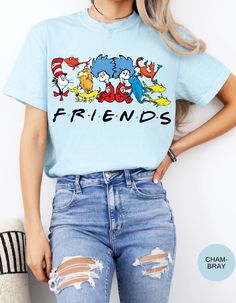 Join the whimsical world of Dr. Seuss with our Seuss Squad Friends Tee! Featuring beloved characters from the enchanting stories of Dr. Seuss, this shirt brings a splash of nostalgia and fun to your wardrobe. Made from soft, premium cotton, it offers all-day comfort and durability. Whether you're a lifelong fan or introducing these classic tales to a new generation, this tee is perfect for showing off your Seuss spirit. Ideal for casual outings, school, or cozy days at home, the Seuss Squad Friends Tee is a delightful addition to any Seuss lover's collection. Embrace the joy and magic of Dr. Seuss with this charming and colorful shirt! Spring Crew Neck Shirt With Character Print, Trendy Relaxed Fit Shirt With Character Print, Themed Cotton Shirt With Cartoon Print, Themed Cotton Short Sleeve Tops, Trendy Crew Neck Shirt With Character Print, Themed Cartoon Print Crew Neck T-shirt, Themed Pre-shrunk Cotton T-shirt, Themed Cotton Crew Neck T-shirt, Themed Cotton T-shirt With Letter Print