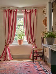 a room with a chair, window and rug