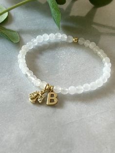 - Beautiful custom guardian angel bracelet with initial is the sweetest bracelet to have in your collection. Wear it for protection or as reminder of a loved one. Personalized angel bracelet is strung on high quality stretch cord and secured. - 4.5mm white jade beads    4mm 18k gold filled accent beads   gold angel charm with cubic zirconia - Each purchase is sent in a drawstring velvet jewelry bag, making a special loss bracelet gift, sympathy gift, anyone special or just for yourself.  - To ca White Hypoallergenic Name Bracelet For Anniversary, Hypoallergenic White Name Bracelet For Anniversary, Personalized Spiritual Beaded Bracelets For Anniversary, White Spiritual Bracelets For Anniversary, Personalized Adjustable Spiritual Charm Bracelet, Adjustable Personalized Spiritual Charm Bracelet, White Charms Bracelet For Anniversary, White Charms Bracelets For Anniversary, White Spiritual Charm Bracelet For Friendship