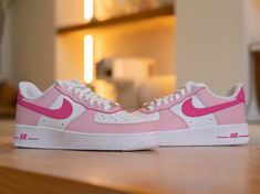 Step up your sneaker game with our Custom Pink Nike Air Force 1 Sneaker! These bold kicks will make a statement as you take on any challenge. The unique design adds a touch of risk-taking to your style. Step out in confidence and show off your adventurous side with these sneakers. 🔥 100% genuine, Brand New.👟 Custom sneakers.★Every pair is hand-made and unique.✨Best quality waterproof and scratch-proof paints used.🎉 1000+ satisfied customers across various platforms.🎁 Treat the shoes as art a Pink Custom Sneakers With Contrast Sole For Streetwear, Pink Custom Sneakers With Gum Sole For Streetwear, Pink Gum Sole Sneakers For Streetwear, Modern Pink High-top Sneakers, Custom Sneakers With Boost Midsole For Light Sports, Pink Mid-top Custom Sneakers With Contrast Sole, Modern Pink High-top Custom Sneakers, Modern Pink Lace-up Custom Sneakers, Pink Mid-top Custom Sneakers For Streetwear