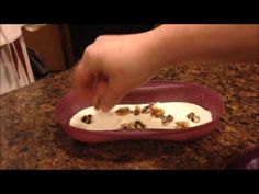 a person dipping some food into a bowl