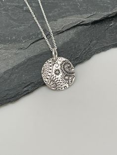 This beautiful circle silver necklace pendant has been entirely handmade using .999 fine silver. It has been cut from fine silver precious metal clay, textured, fired and oxidized. The pendant hangs from a sterling silver diamond cut cable chain. This unique and handmade necklace features an embossed floral paisley textured pattern. Pendant size: approximately 1/2 x 1/2 inches Chain length: adjustable at 16 and 18 inches can also be customized to whatever length needed The necklace is sent in a Etched Sterling Silver Round Disc Jewelry, Bohemian Sterling Silver Pendant Charm Necklaces, Unique Etched Sterling Silver Necklace, Unique Silver Etched Necklaces, Etched Sterling Silver Necklaces, Silver Etched Sterling Silver Necklace, Bohemian Sterling Silver Charm Necklace Nickel Free, Bohemian Sterling Silver Charm Necklaces In Silver, Silver Etched Necklace With Flower Pendant