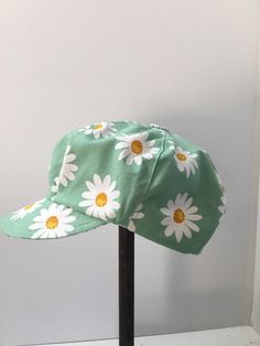 "Womens newsboy, slouchy cap has been sewn from a fresh green white daisy print. The cap is fully lined , with a topstitched brim or peak. The six panels have been finished with a hand made button. This is a bright summer casual cap.. pop it on to go shopping, wear on the weekend with jeans or take on holiday.... Foldable and washable.... (the fabric has been  prewashed) There is an elastic cord for adjusting. Please check your head measurements with those below. A comfy and soft cap which sits Summer Sewing, Casual Cap, White Daisy, How To Make Buttons, Newsboy Cap, Daisy Print, Fresh Green, Go Shopping, Week End