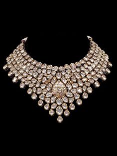 "Mendhika Jadau Polki Set A gold tone chunky Polki Jadau Necklace Set with big Kundan stones. An array of mini polki pieces encircle a jadau kundan pear shape motif with beautiful matching jhumkis/earrings. Can be worn with a statement long necklace for a bridal jpiece. Approximate earrings length is 3.5\". * Check out Manpreet Toor wearing this for a shoot to see the entire look! Tikka and different set of earrings can be added for additional cost. Gold-plated on high-quality brass as base meta Kundan Sets Indian Jewelry, Shaadi Jewelry, Polki Tops, Girly Jewellery, Manpreet Toor, Kundan Bridal Jewellery, Jadau Necklace Set, Kundan Polki Necklace, Jewelry Banner