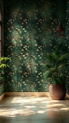 two potted plants in front of a green wallpapered with flowers and vines