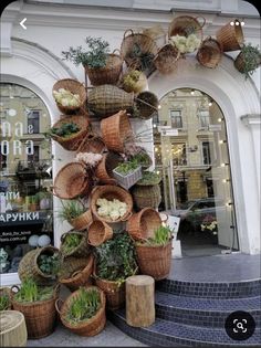 several baskets are stacked on top of each other in front of a storefront window