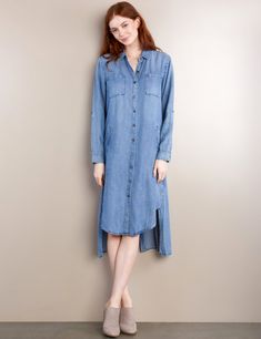 Wear your mood, in the beautiful Chill Out Shirt Dress in soft Lyocell, with front pockets, button-front and sleeves, and Hi-Lo hem. The model is 5'7" wearing size Extra Small Fabric: 100% Lyocell Length: 42" from shoulder Below The Knee Dresses, Denim Vests, Denim Overall Dress, Cropped Flare Jeans, Denim Romper, Jean Accessories, Knee Dress, Overall Dress, Shirtdress