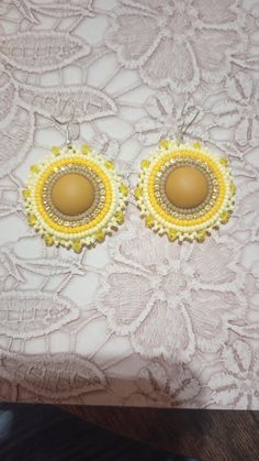 pretty yellow earrings! Beaded with yellow seed beads and rhinestone banding, around a matte Yellow center. Edged with seed beads ! backed with faux leather backing, on silver hooks 💛 💛  thank you for looking!! Yellow Beaded Earrings With Colorful Beads, Yellow Beaded Earrings With Multicolor Beads, Yellow Round Beaded Earrings, Yellow Beaded Earrings With Gold Round Beads, Adjustable Yellow Earrings With Gold Beads, Handmade Yellow Beaded Round Earrings, Yellow Earrings With Gold Beads, Yellow Gold Beaded Round Earrings, Yellow Beaded Earrings