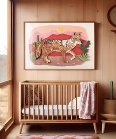 a baby's room with an animal painting on the wall