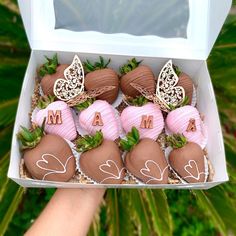 chocolate covered strawberries in a box with the letters m and m painted on them