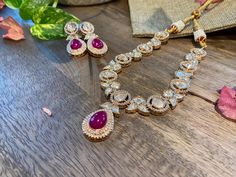 This Designer Short Uncut Polki Party Wear Necklace Set blends the timeless elegance of Polki stones with a modern twist. * Exquisite Indian wedding choker necklace set * High Quality Kundan and moissanites  with a centered carved ruby stone * 22 karat gold-plated for a luxurious, timeless appeal * artistic craftsmanship in every detail * Adjustable necklace length for a comfortable fit * Comes with matching earrings to complete the set * Necklace Length: 12.0 inches Earrings Length: 1.5 inches Luxury Hand Set Kundan Necklaces, Luxury Pink Kundan Bridal Necklace, Wedding Choker Necklace, Sabyasachi Jewelry, Sabyasachi Jewellery, Moissanite Necklace, Wear Necklaces, Choker Necklace Set, Choker Set