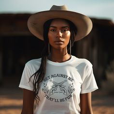 Bet Against Me That'll Be Fun Pistols t-shirt for country girls and cowgirls is a Next Level brand tee and comes in unisex cut and sizes. This graphic tee features guns and roses so to speak with its six-shooter pistols crossed in the center and pretty dainty flowers on each side. Cowgirls have a soft side until you cross them, right? This graphic tee for cowgirls is a personal favorite since my daddy called me Annie Oakley growing up. A vintage style graphic for the modern cowgirl. Looks perfec Six Shooter, Nashville Bachelorette Party, Modern Cowgirl, Annie Oakley, Dainty Flowers, Nashville Bachelorette, Party Music, Music Concert, Country Girls