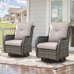 two wicker chairs sitting on top of a wooden floor next to a white house