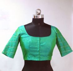 Blue green pure raw silk blouse with geometric hand embroidery on the sleeves. Custom fitted. -Measurements sheet will be sent to you once you order( Standard sizing also available) -Custom colors available -Work on front back and sleeves. Please convo me if you're have any specific requirements. This blouse can be done with or without the bust cup inserts . The blouse is fully lined is cotton. Usual turn around time is 1-2 weeks, but we may be able to accomodate emergency requests if possible. Fitted Green Tops With Resham Embroidery, Fitted Green Blouse With Resham Embroidery, Green Silk Blouse Piece With Padding, Fitted Silk Tops With Resham Embroidery, Fitted Green Raw Silk Choli, Designer Fitted Green Blouse, Green Silk Padded Blouse, Green Fitted Short Sleeve Choli, Fitted Green Blouse With Cutdana Details