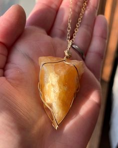 ☾ Raw Orange Calcite Necklace ☾ High quality, medium - large rough orange calcite in its raw form in a secure & subtle setting that highlights the stone These pendants come in pure copper, 14k gold, or sterling silver. Choose from an adjustable faux leather chord, a matching 18" copper chain, a matching 18" sterling silver chain, a matching 14k gold chain or get just the pendant. ⭐️Faux Leather Chord Options: Choose from black, dark brown or tan. These chords are also tied to be adjustable so yo Calcite Jewelry, Orange Calcite Crystal, Calcite Necklace, Raw Crystal Necklace, Orange Calcite, Calcite Crystal, Copper Chain, Raw Crystal, Pure Copper