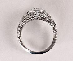 an antique style diamond ring on a white background