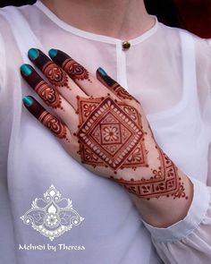 a woman's hand with henna on it