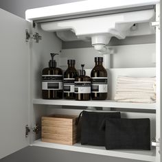 an open cabinet filled with lots of different types of soaps and lotion bottles