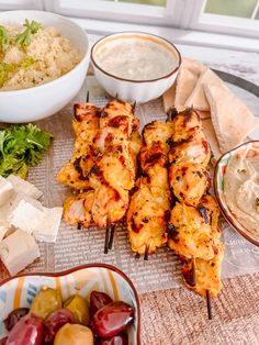 there are many different foods on the table and one is skewing them out