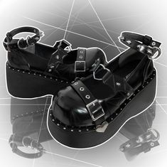 Step into a world of enchanting style with these platform Mary Jane shoes. Designed with a bold and unique aesthetic, these shoes feature an ankle strap adorned with striking stud decorations, adding an edgy touch to your outfit. The upper part showcases a captivating devil wing design, intricately connected by a charming heart-shaped ring, making a statement wherever you go. The toe area is elegantly finished with a heart-decorated buckle strap, adding a sweet yet rebellious flair. Perfect for Punk Heels With Platform And Round Toe, Punk Style Platform Heels With Round Toe, Punk Style Round Toe Heels With Platform, Punk Ankle-high Platform Heels, Punk Style Ankle-high Platform Heels, Punk Platform Heels For Concert, Edgy Platform Heels For Alternative Fashion, Alternative Style Platform Heels, Edgy Platform Heels With Ankle Strap