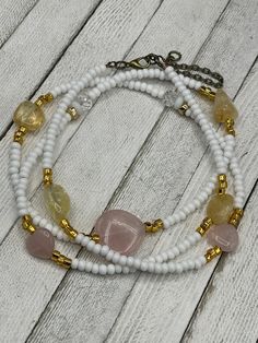 Looking for a meaningful accessory that will bring positivity and good energy into your life? Look no further than these Crystal Waist Beads, handmade to order by Vee Webb of Luxe Adornments Co. Crafted from the highest quality materials, these waist beads feature a heart-shaped rose quartz, tumbled citrine, and hematite, all known for their powerful metaphysical properties. Rose quartz is believed to promote love and self-care, citrine is said to attract abundance and prosperity, and hematite i Adjustable White Rose Quartz Jewelry, Adjustable Rose Quartz Round Bead Necklace, Adjustable Rose Quartz Necklace With Round Beads, Adjustable Rose Quartz Crystal Necklace With Natural Stones, Adjustable Rose Quartz Beaded Necklace As Gift, Healing Beaded Rose Quartz Jewelry, Adjustable Rose Quartz Beaded Necklace For Gift, Adjustable White Gemstone Crystal Necklace, Adjustable Rose Quartz Beaded Necklace For Healing