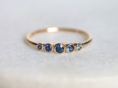 Blue sapphire ring, Blue sapphire stacking ring, dainty ring, stacking ring, stackable ring, blue sapphire ring, Sapphire ring Available in 9k/14k/18k yellow, rose or white gold. Same design can be made also with other custom gemstones per request. Product details: - Solid gold - approx 2.5, 2, 1.5 mm sapphire round - Band size is 1.2mm Ring size - US 3 to US 9 (for smaller or larger ring size, please contact) Please select your size at the drop down menu. Service Available - Customization Avail Adjustable Blue Sapphire Ring Fine Jewelry, Blue Sapphire Stackable Rings For Promise, Adjustable Stackable Blue Sapphire Ring, Blue Adjustable Stackable Rings, Fine Jewelry, Adjustable Blue Stackable Rings, Fine Jewelry, Blue Adjustable Stackable Fine Jewelry Rings, Blue Adjustable Stackable Fine Rings, Handmade Fine Jewelry Blue Rings, Blue Stackable Rings With Bezel Setting