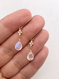 Rainbow Moonstone Earrings, Teardrop Dangle Earrings, Minimalist Gold Earrings, June Birthstone, Small Moonstone Earrings, Gift for women These precious delicate earrings feature blue flash rainbow moonstone teardrops adorned with a white topaz connector in either gold filled or sterling silver. The earrings are suspended from lever back ear wires in the finish of your choice. These earrings are very feminine and subtle, perfect for every day and the moonstone makes them suitable for almost any Elegant Moonstone Dangle Crystal Earrings, Moonstone Crystal Dangle Earrings, Delicate Dangle Moonstone Earrings, Minimalist Moonstone Jewelry With Ear Wire, Delicate Dangle Moonstone Jewelry, Delicate Teardrop Moonstone Earrings, Delicate Moonstone Dangle Jewelry, Dainty Teardrop Gemstone Earrings, Dainty Teardrop Crystal Single Earring