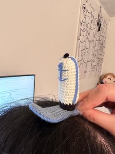 a crocheted cell phone holder sitting on top of a woman's head