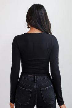 The Sloane Everyday Black Long Sleeve Crop Top is a must-have staple for every wardrobe. This sleek, fitted top features a classic scoop neckline that flatters your silhouette while offering a touch of understated elegance. Made from a soft, stretchy fabric, it hugs your curves comfortably and moves with you throughout the day. The cropped length makes it perfect for pairing with high-waisted jeans, skirts, or joggers for a chic, balanced look. Whether you're dressing it up with accessories for Black Scoop Neck Top For Night Out, Scoop Neck Tops For Night Out In Fall, Fall Scoop Neck Top For Night Out, Sleek Fitted Top For Night Out, Sleek Tops With Scoop Neck And Minimal Stretch, Sleek Scoop Neck Tops With Minimal Stretch, Sleek Top With Scoop Neck And Minimal Stretch, Sleek Scoop Neck Top For Night Out, Sleek Solid Color Scoop Neck Top