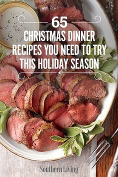 a white plate topped with roast beef and greens next to a fork, knife and spoon