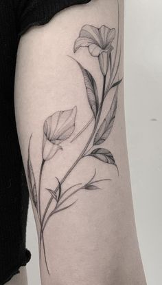 a black and white photo of a flower on the thigh