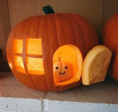 a pumpkin carved to look like a house