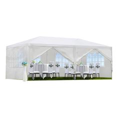 a large white tent with tables and chairs