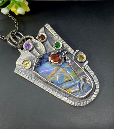 "Carved Australian Opal gemstone pendant necklace in sterling silver Hand-made Sterling Silver 925. Stones used: Australian Opal, Citrine, Amethyst, Garnet, Chrome Diopside Height - 2 1/4\" (with bail), Width - 1 1/4\" Chain length 20 inches Unique Handcrafted One-of a-kind Design Pendant Each Piece of Jewelry in my Collection is Absolutely One of a Kind! When you start wearing a piece of my jewelry you will fall in love with it more and more each day and feel that good Energy and Love that I pa Artisan Silver Necklace With Rectangular Pendant, Unique Silver Necklace With Rectangular Pendant, Unique Silver Rectangular Pendant Jewelry, Artistic Silver Jewelry With Large Pendant, Unique Silver Square Pendant Jewelry, Unique Sterling Silver Square Pendant Jewelry, Unique Sterling Silver Necklace With Rectangular Pendant, Hand Forged Silver Rectangular Pendant Necklace, Hand Forged Sterling Silver Necklace With Rectangular Pendant