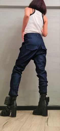 "Extravagant Denim Pants, Harem Casual Pants, Urban Pants, Loose Pants, Punk Pants, Gothic Pants, Outer pockets, New collection ❤️ Extravagant designs and high quality fabrics! ❤️ Materials & Care Denim Hand wash at low temperatures. Do not machine dry. Do not iron. Do not dry clean! ❤️ Sizing We can make your piece from XS to 5XL! Everything in the shop can be also made according to your measures free of charge! ❤️ Shipping ✈ Ready to ship The time I need to prepare an order for shipping va Tapered Leg Denim Blue Pants With Pockets, Denim Blue Tapered Leg Pants With Pockets, Punk Style Wide Leg Jeans, Baggy Denim Punk Pants, Punk Style Wide Leg Denim Pants, Punk Wide Leg Denim Pants, Baggy High-waisted Jeans With Pockets, Baggy Dark Wash Pants With Pockets, Fitted Cargo Style Jeans With Tapered Leg