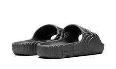 The adidas Adilette Slide 22 “Grey” is a colorway of the comfortable slip-on sandal that’s made from sustainably sourced materials.  Reminiscent of the adidas Yeezy Slide, the Adilette 22 has a contemporary vibe with wavy lines inspired by 3D topography.  The sandal  is made from lightweight EVA foam that contains up to 25% plant-based ingredients derived from sugarcane.  The “Grey” colorway features a monochromatic grey appearance with “The Brand With the Three Stripes” branding on the lateral Adidas Yeezy Slide, Stripes Branding, Yeezy Slides, Wavy Lines, Adidas Adilette, Stadium Goods, Grey Shoes, Eva Foam, Adidas Yeezy