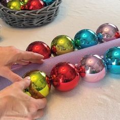 someone is decorating christmas balls on the table