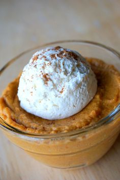 a dessert in a glass bowl with whipped cream on top